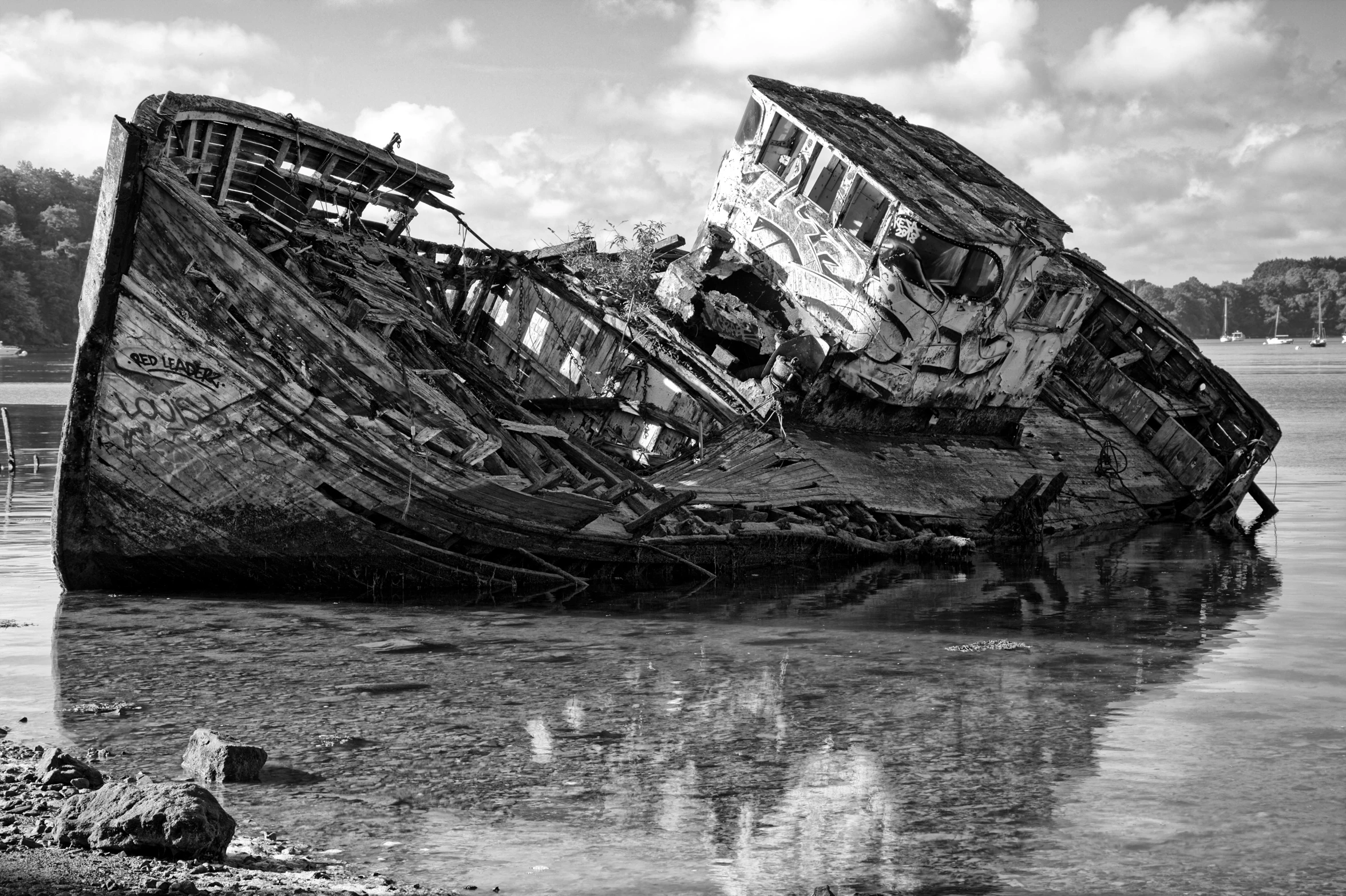 an old wooden boat rests in a body of water