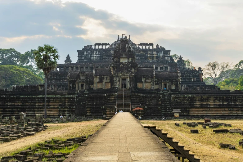 an ancient ruin like building with trees in the background