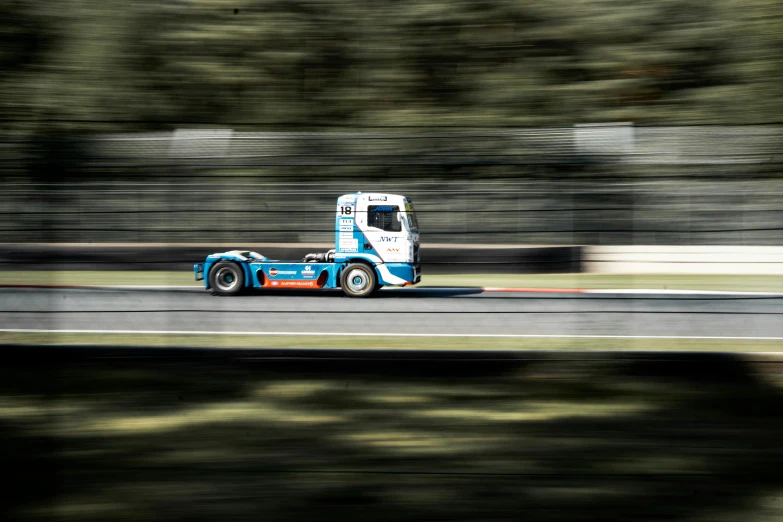 a truck driving down a track during the day