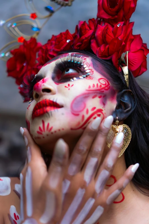 woman in a red and white outfit and head piece painted like a flower