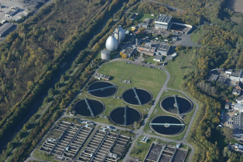 an aerial view of some tanks and trees