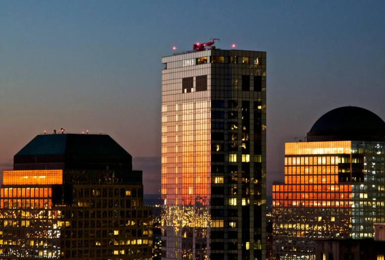 view of skyscrs at night from atop a building