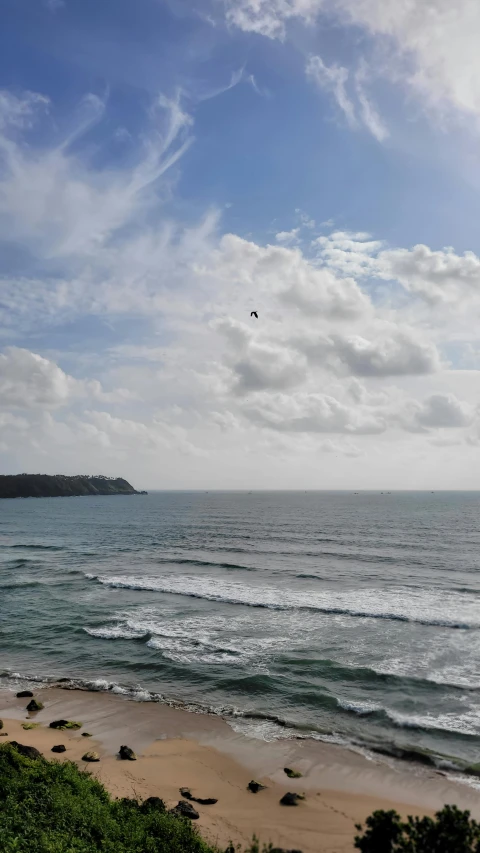 a beautiful beach with water and clouds