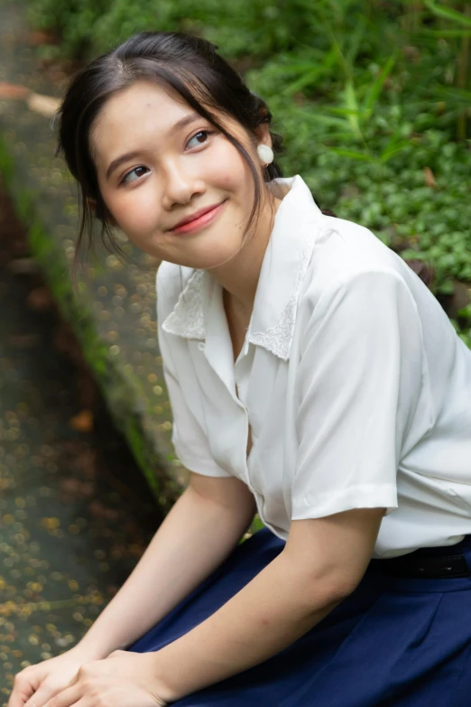 a  smiles while sitting near the water