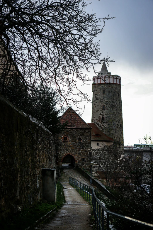 an old stone building next to a large brick tower