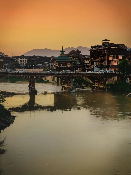 bridge over the river during sunset with buildings