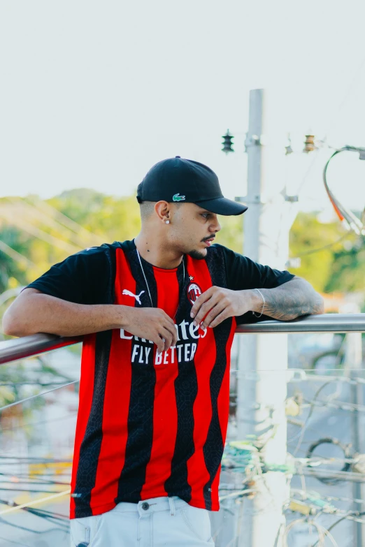 young man in red and black shirt posing for camera