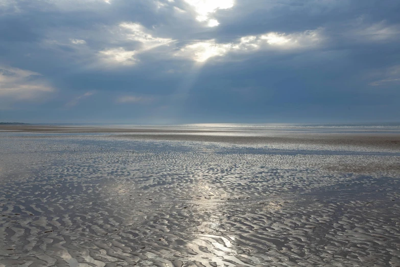 the light shining down on the ocean from the beach