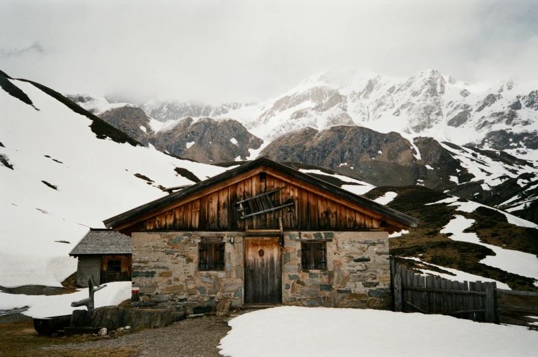 a mountain covered with snow with a building