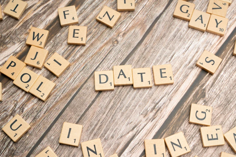 some scrabbled letters spelling out save the date