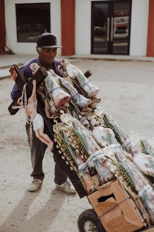 a man pulling a cart full of stuff around