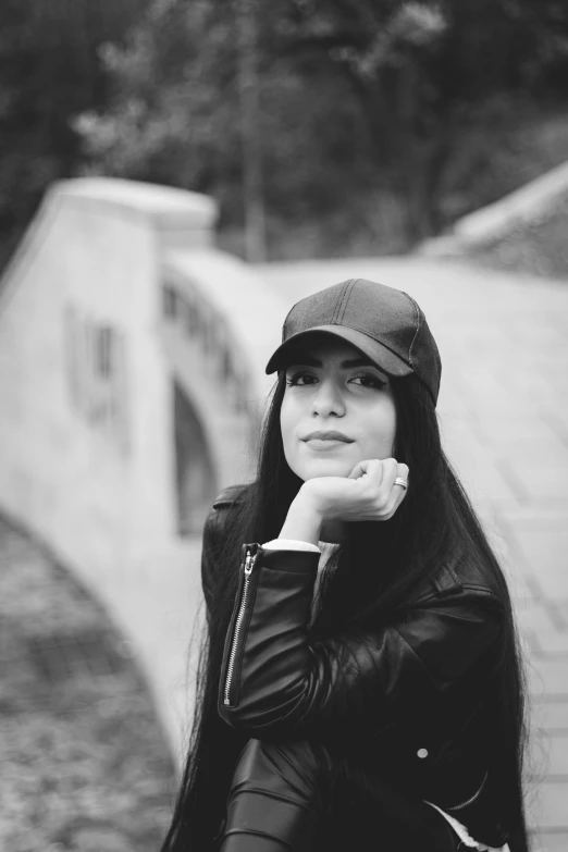 a girl with long black hair is wearing a cap