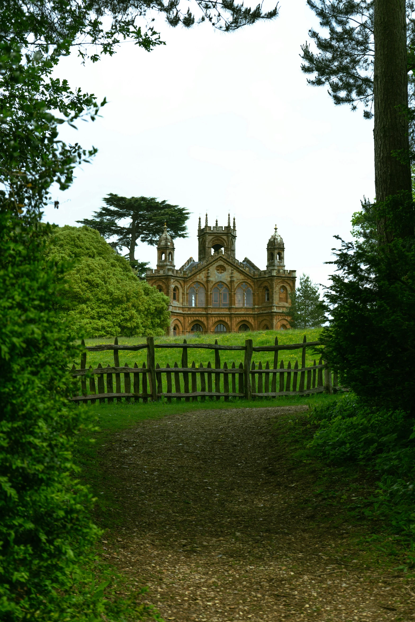 a old country house is situated amongst tall trees