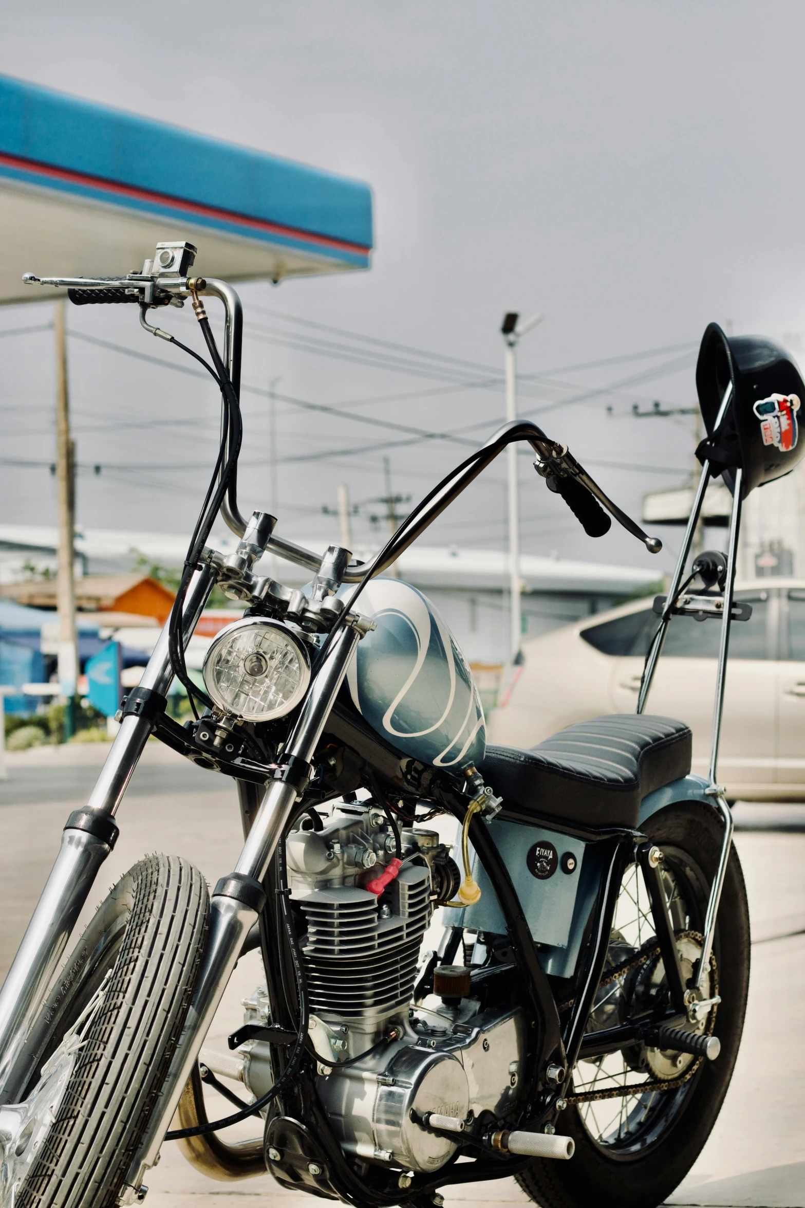 a motorcycle with a small engine parked in a lot