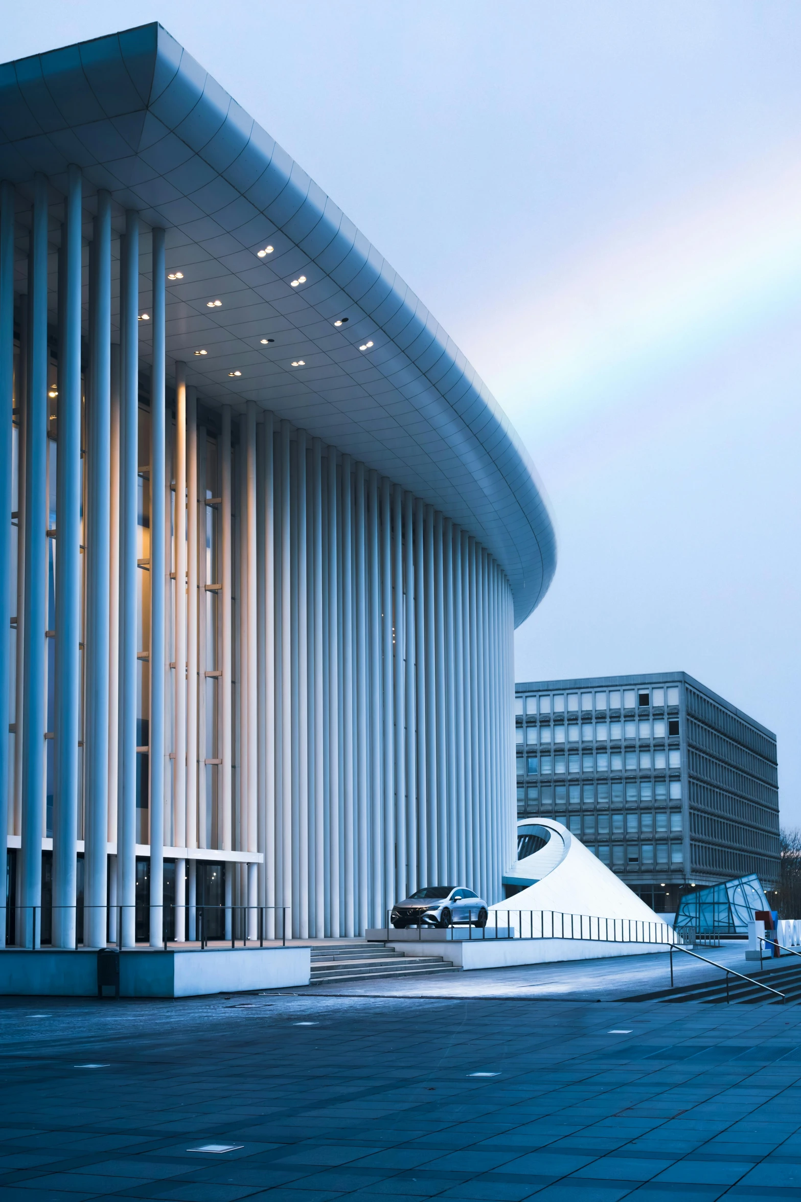 an exterior image of a building that has a white wave on the side of it