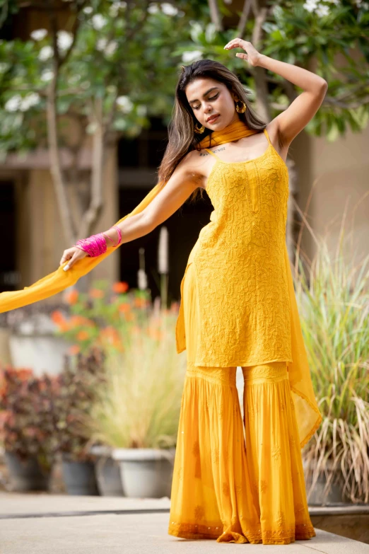 the woman is in a long dress and holding an umbrella