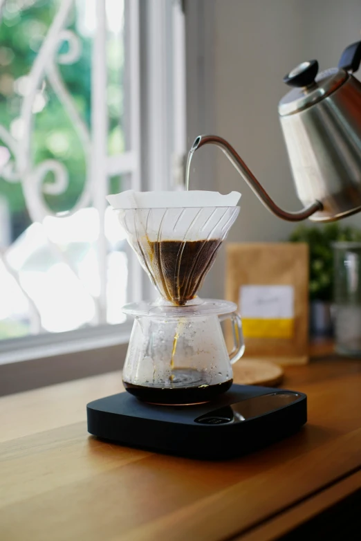 a stove top coffee maker on a wooden counter