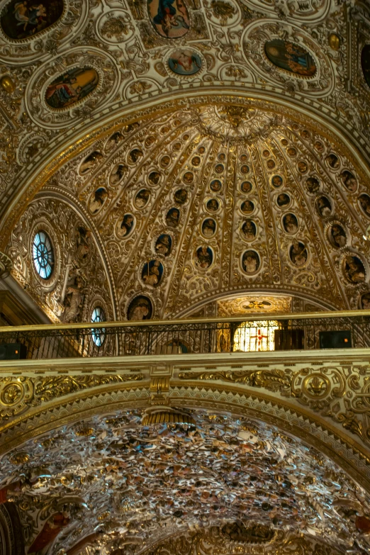 an ornate ceiling and glass in the background