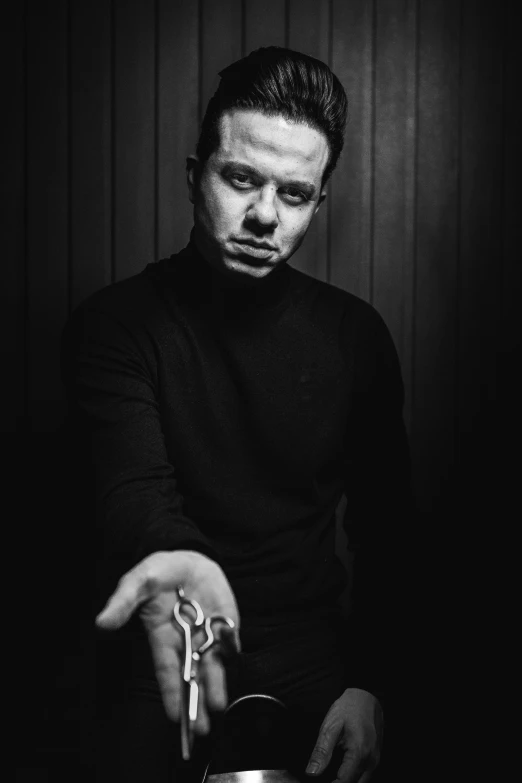 black and white image of a man holding a bowl