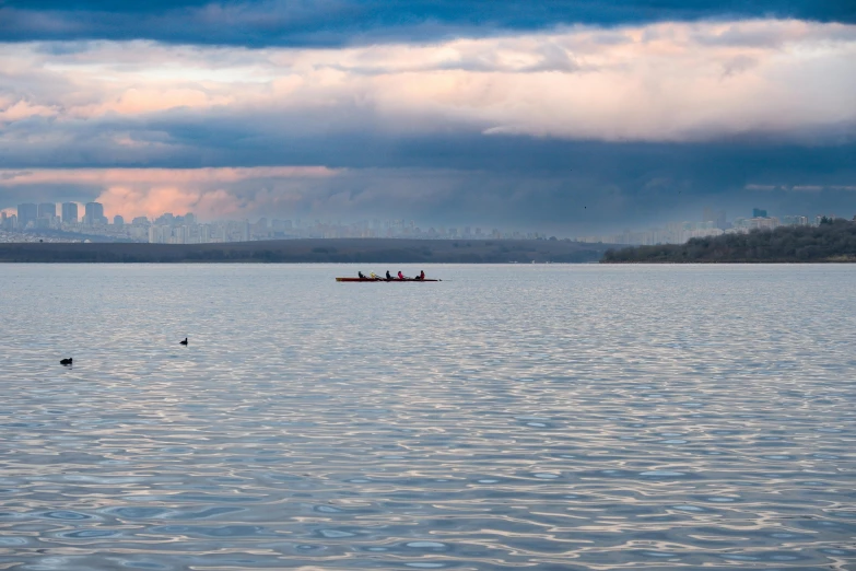 a small boat in the middle of a large body of water