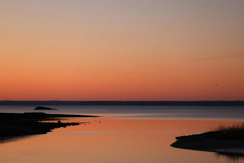 a large body of water that is at sunset