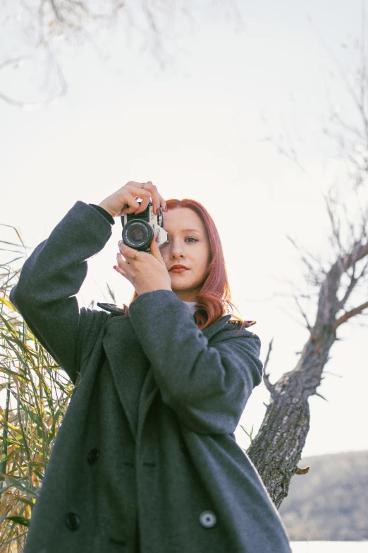 woman holding up a camera taking a picture