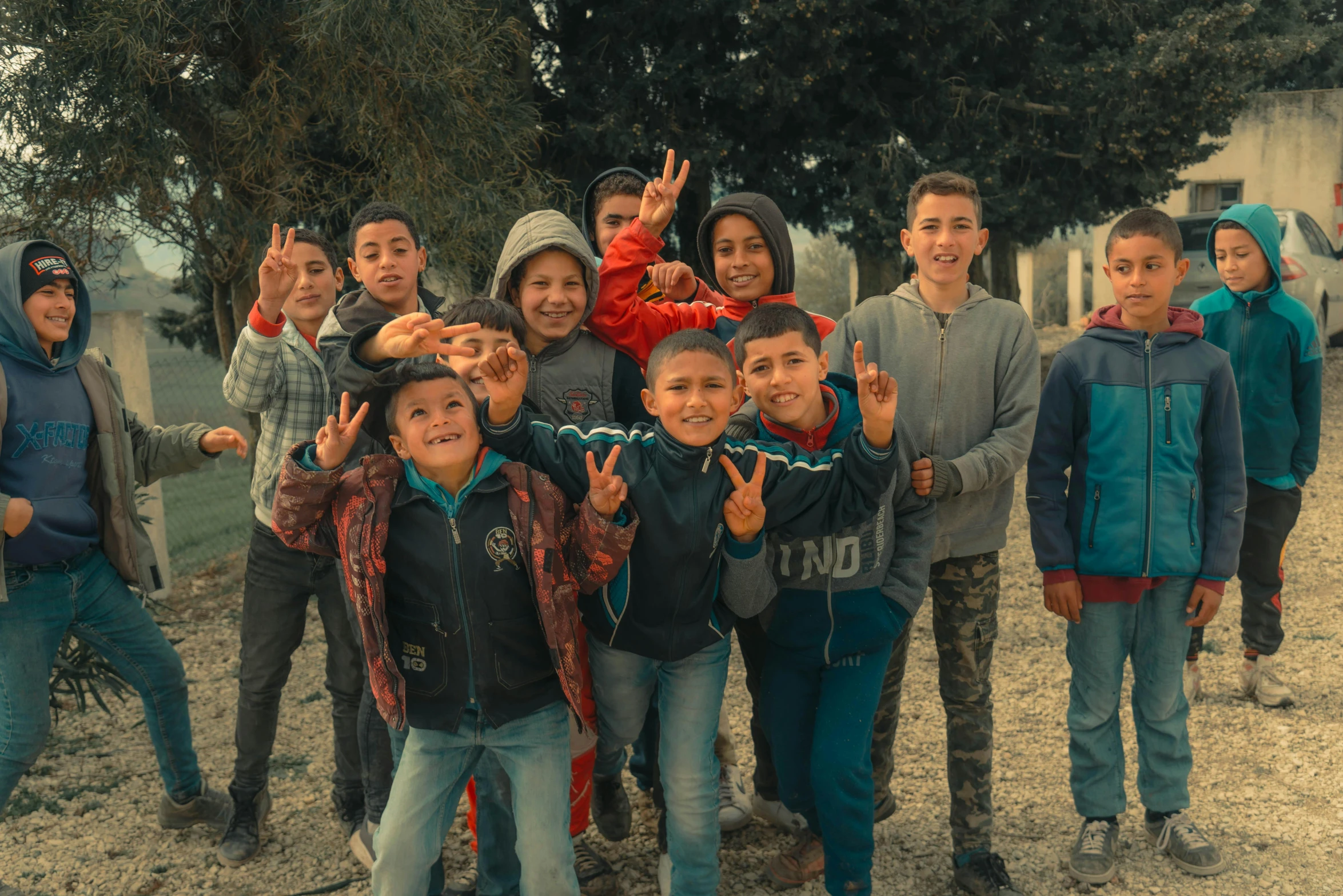 a group of s with a small boy making the peace sign