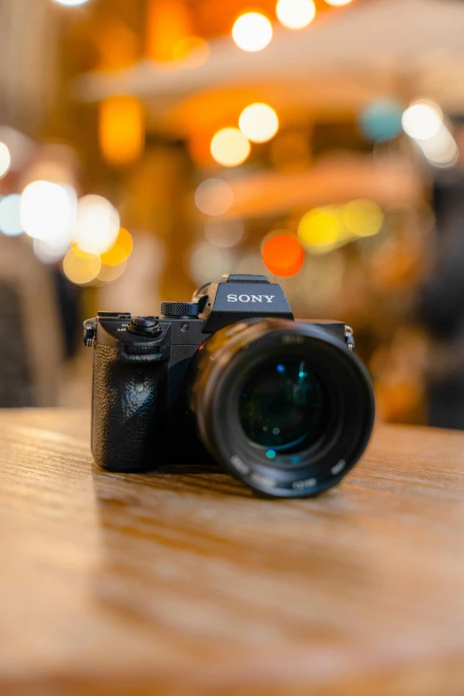 a camera is sitting on a table with blurry lights