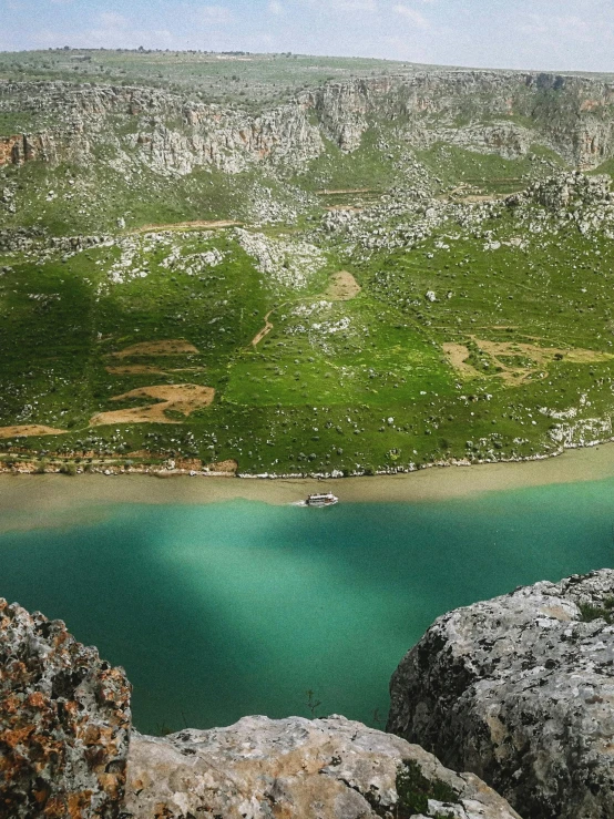 the beautiful green mountain is near a blue lake