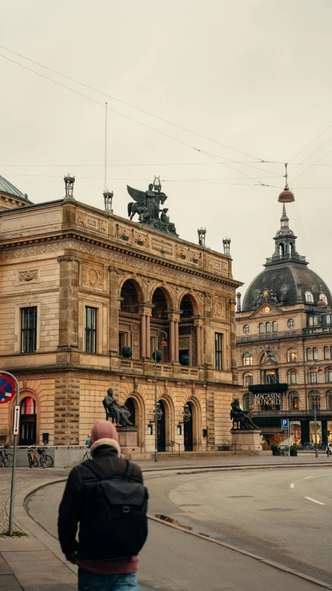 a man walking through a european city street