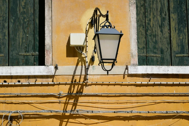 two black lights next to the side of a building