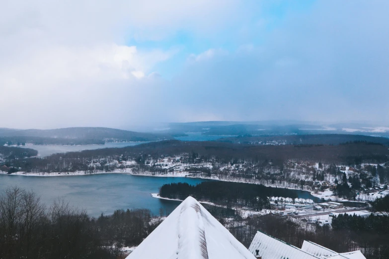 the view from a tall roof of a lake, town and snow covered land