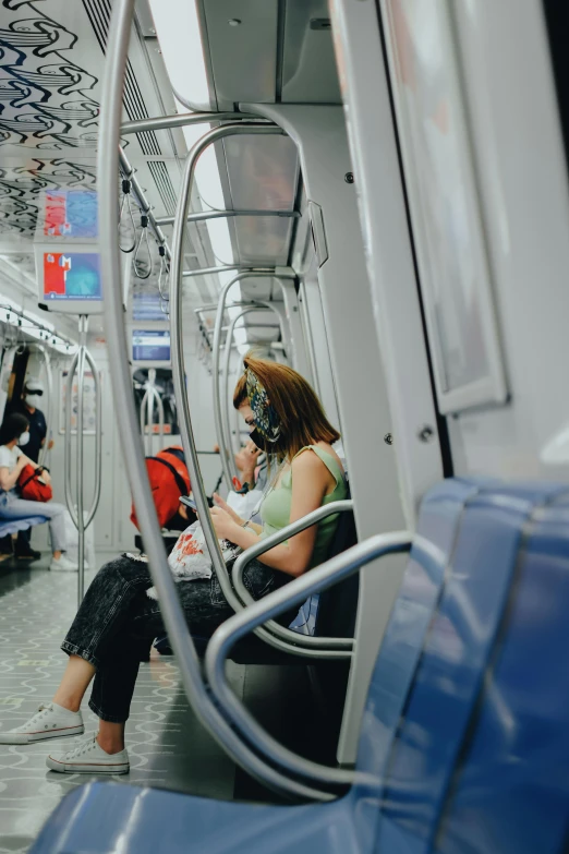 several people are sitting in the public transportation