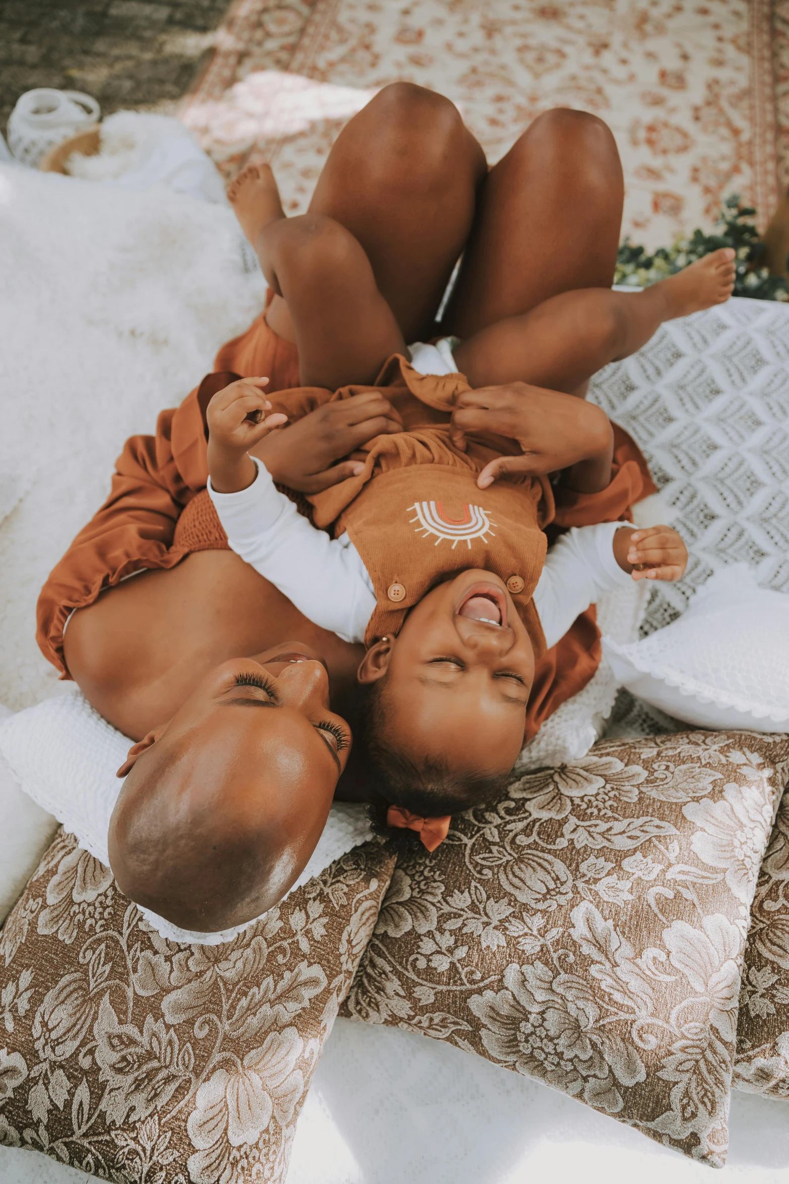 a baby lays on it's side on the ground with two other babies