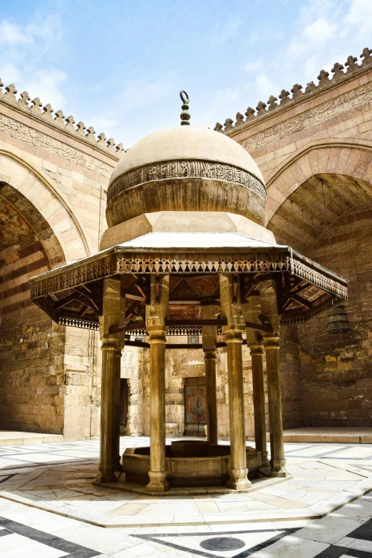 an oriental style gazebo sits in the middle of an arched courtyard