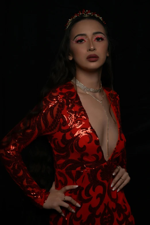 a woman is wearing a shiny red bodysuit