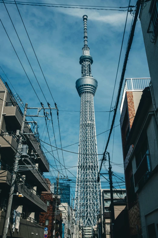 a tall metal tower towering over a city