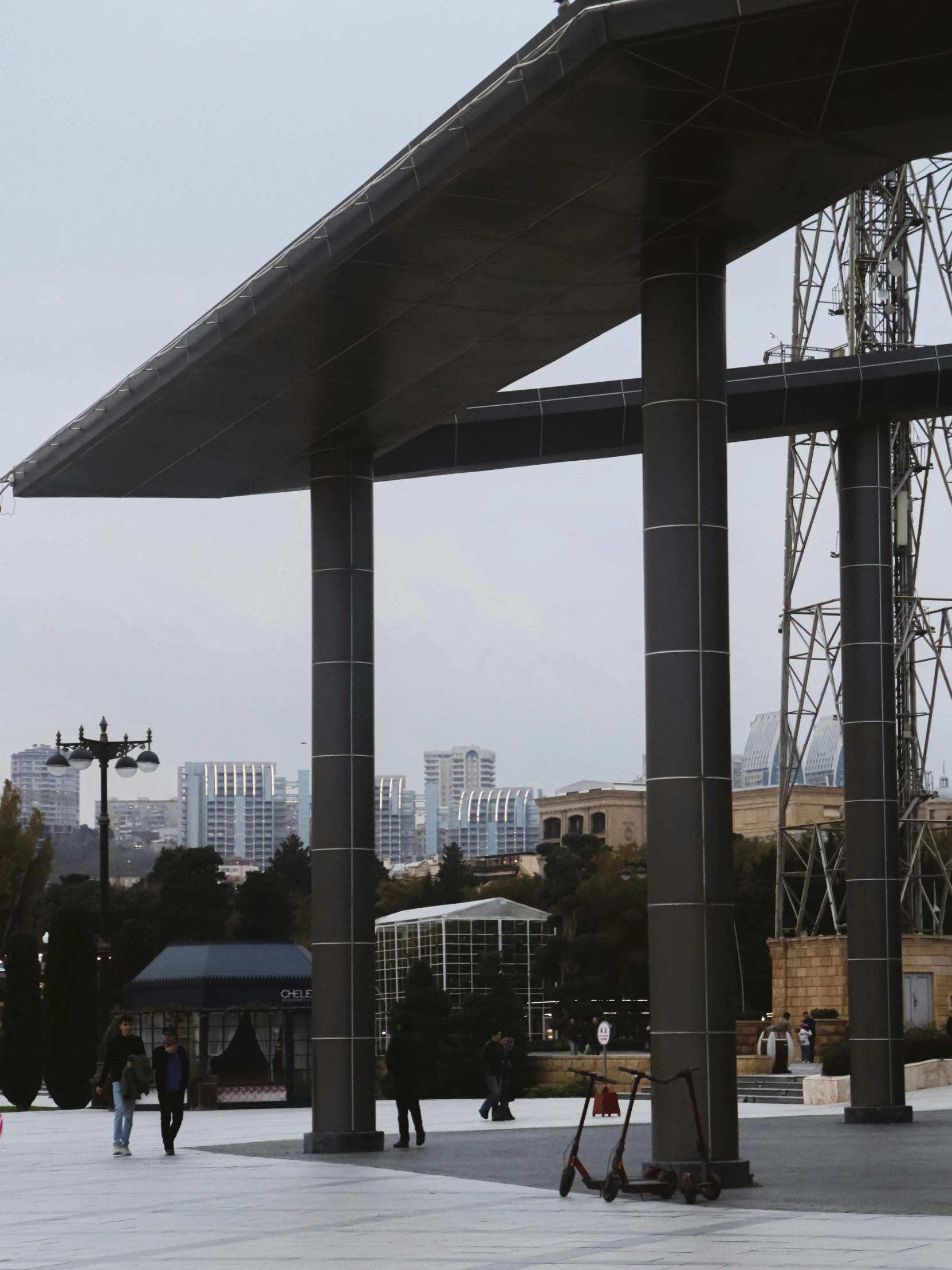 people are standing underneath very tall columns