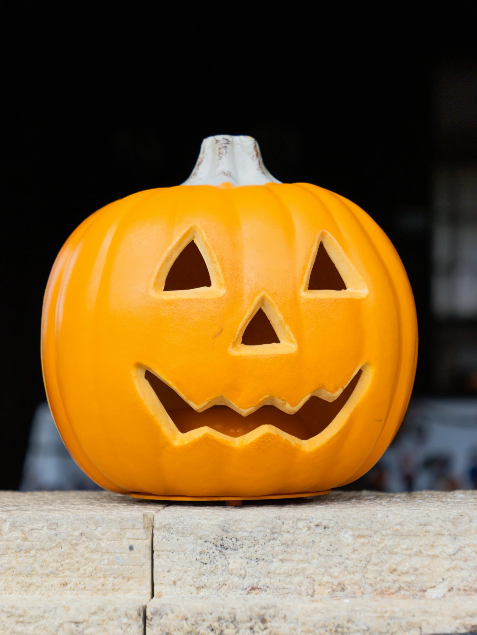 a carved pumpkin with faces carved on the side of it