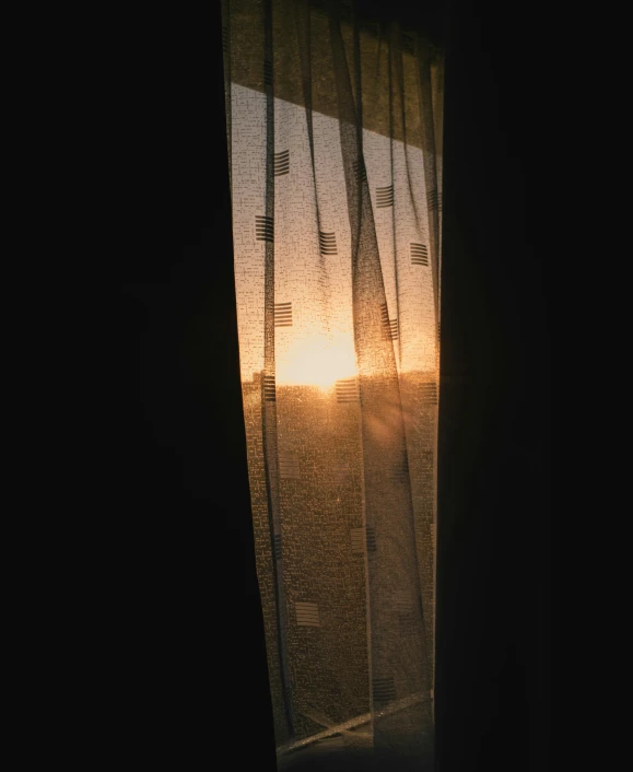 the sun shines through curtains on a window