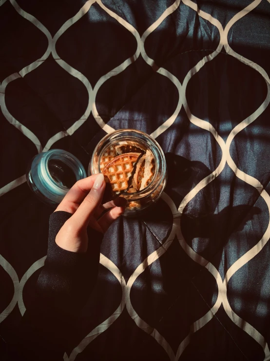 a person holding a jar filled with some food