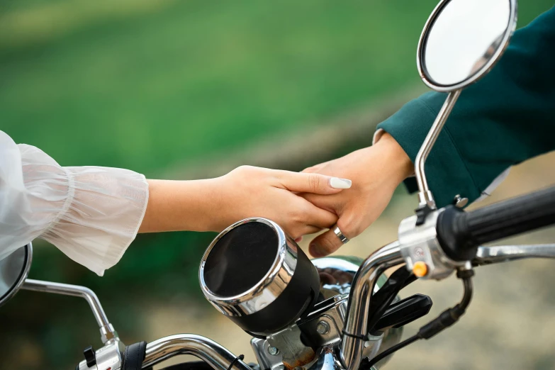 there is a hand on the handlebars of a motorcycle