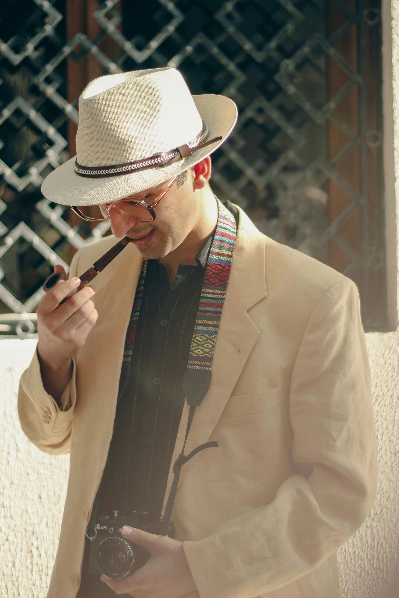 a man in a white hat smoking a cigarette and looking down