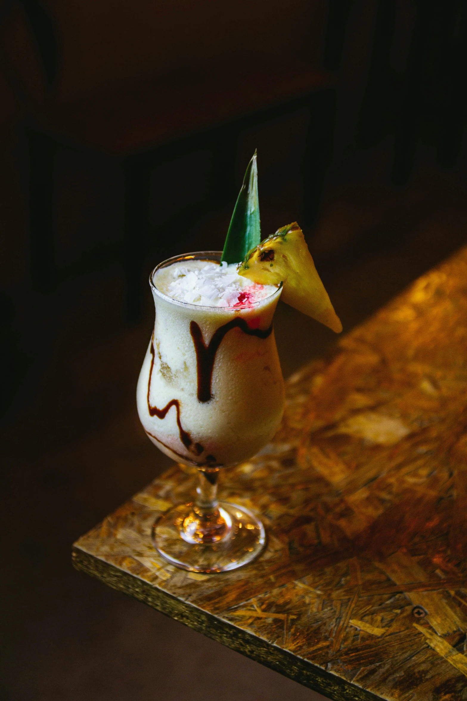 an alcoholic cocktail with whipped cream and chocolate in a decorated cup