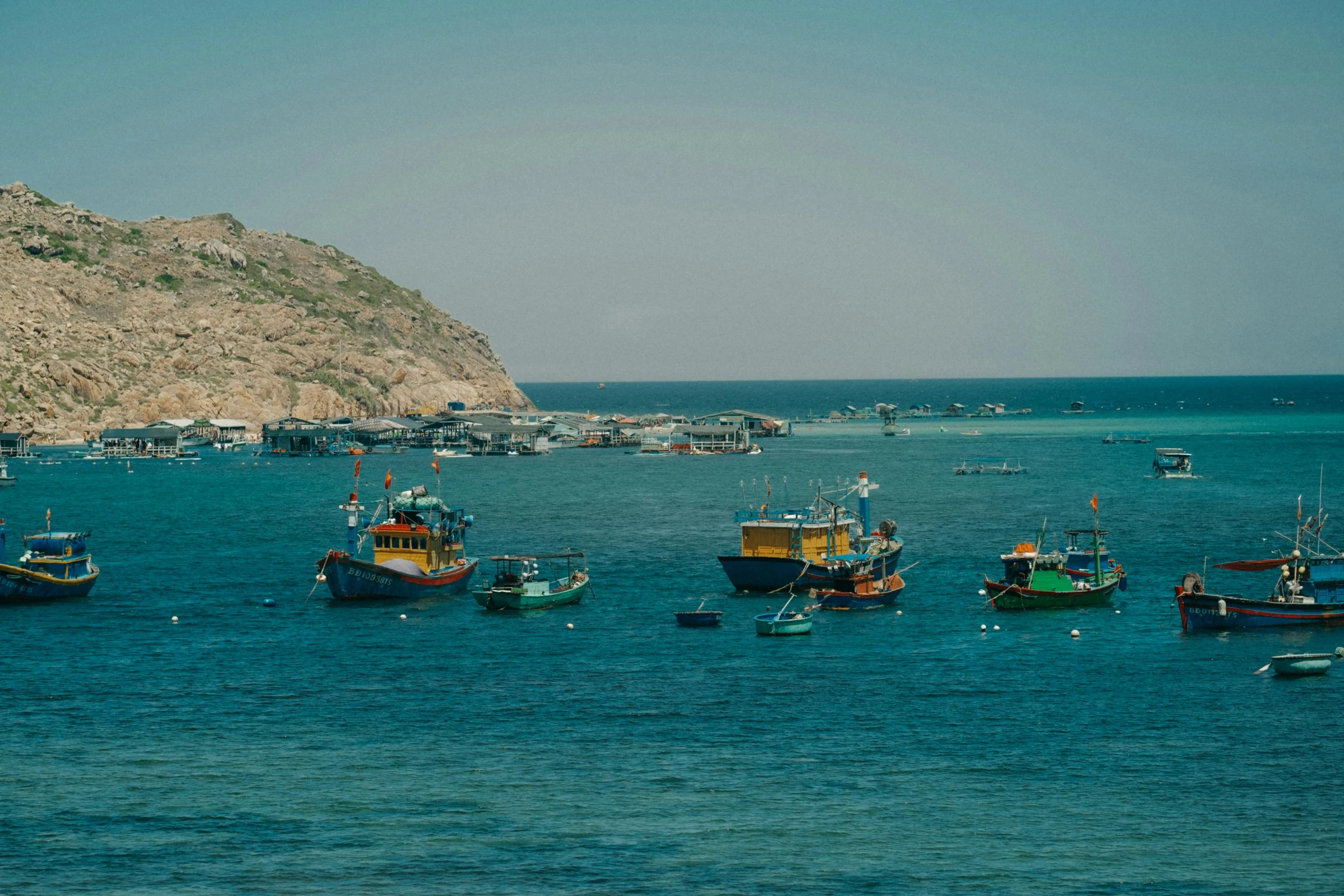 a group of boats floating on top of a lake