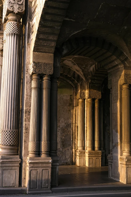 an old and beautiful walkway with columns and arches