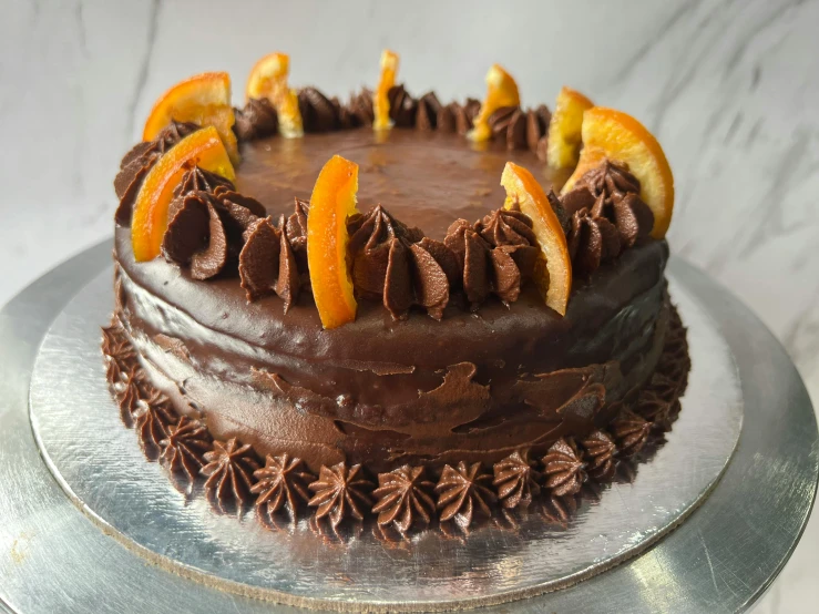 this is a chocolate cake decorated with oranges