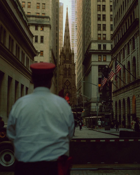 the man is walking on the street in the big city