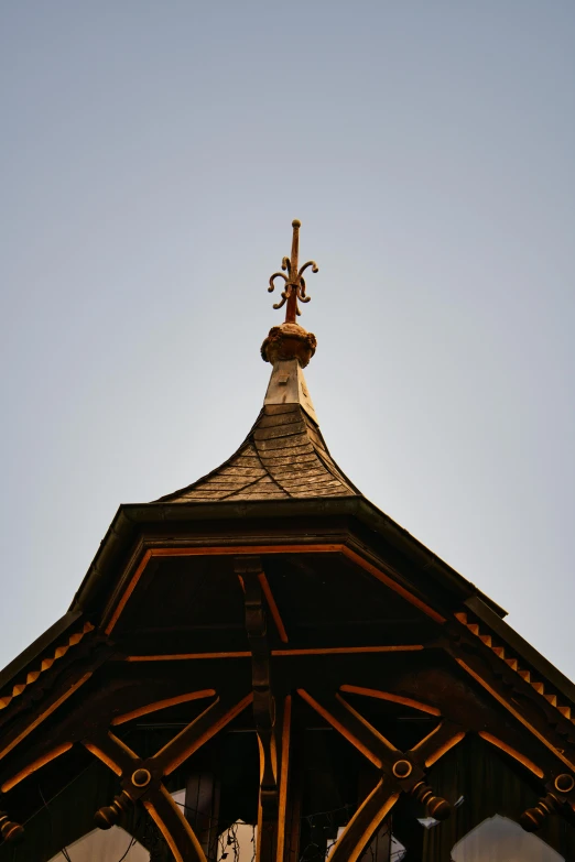 a clock tower with a cross on top