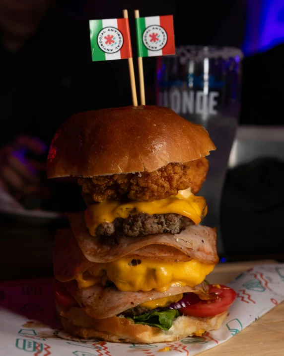 a triple stacked burger with an italian flag